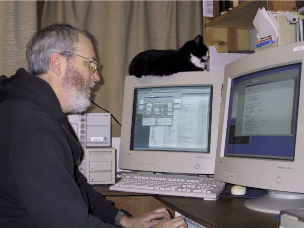 Tim Scully and his cat Merlin, at work in Albion, California, Photograph from Little River Airport